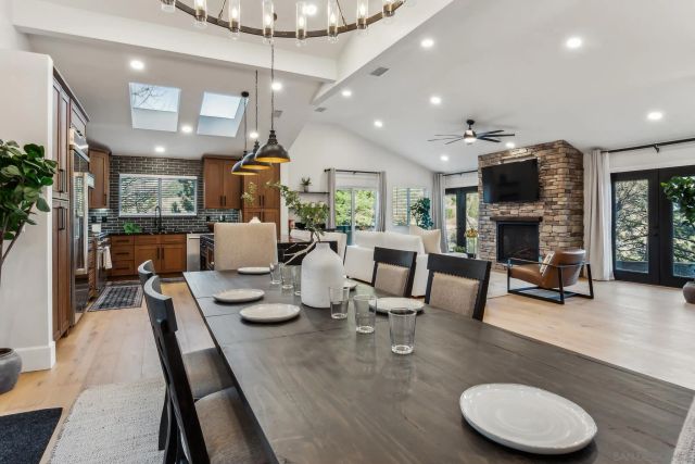 a dining room with kitchen island furniture a chandelier and kitchen view