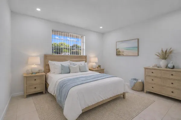 a bedroom with a bed and a painting on the wall