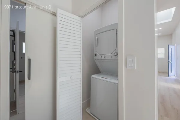 a kitchen with stainless steel appliances white cabinets and a wooden floor
