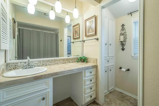 a view of a hallway with wooden floor and dining room view