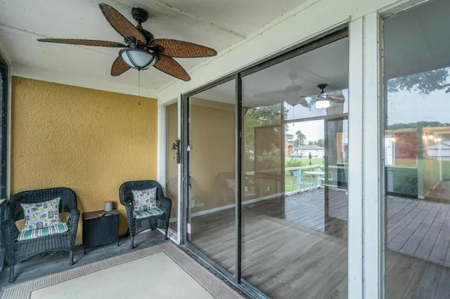a view of house with swimming pool and outdoor seating