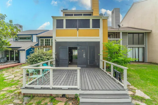 a view of house with backyard and outdoor seating