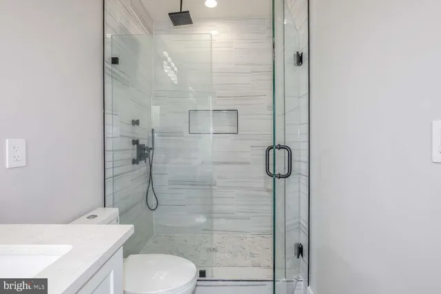 a bathroom with a toilet and a shower
