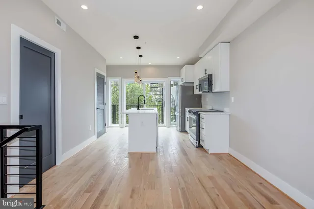 a view of kitchen with furniture and wooden floor