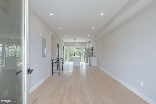 a view of a big room with wooden floor windows and chandelier