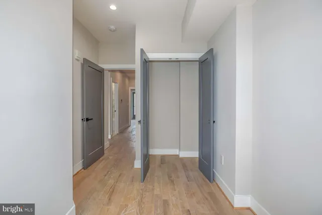 a view of hallway with wooden floor