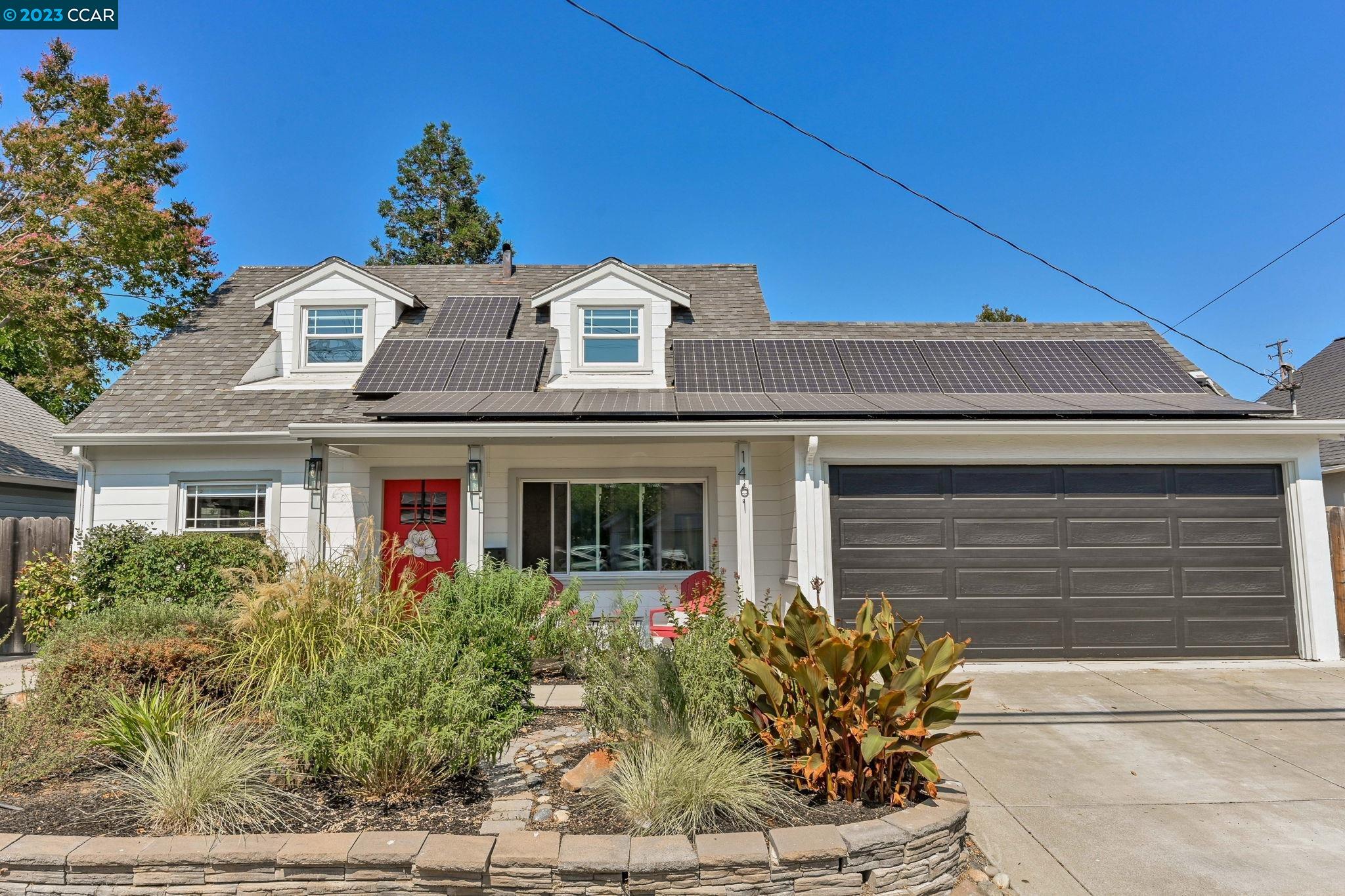 a front view of a house with garden