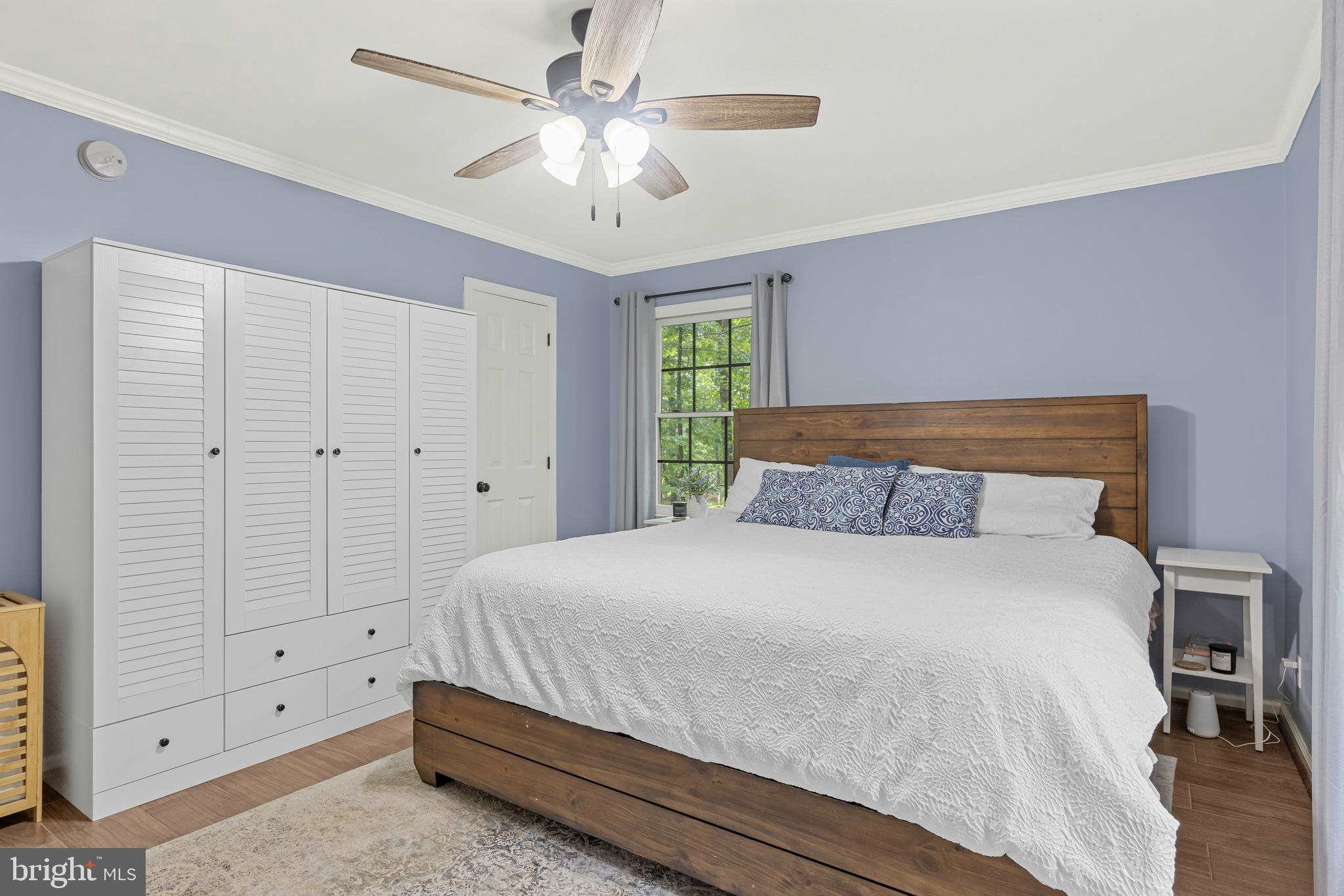 1425 Jacks Shop Road Rochelle, VA 22738 - Photo 23 of 56 a bedroom with a large bed and a chandelier