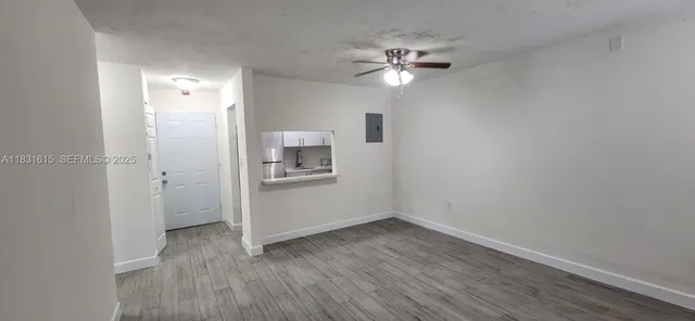 a view of a room with wooden floor and closet