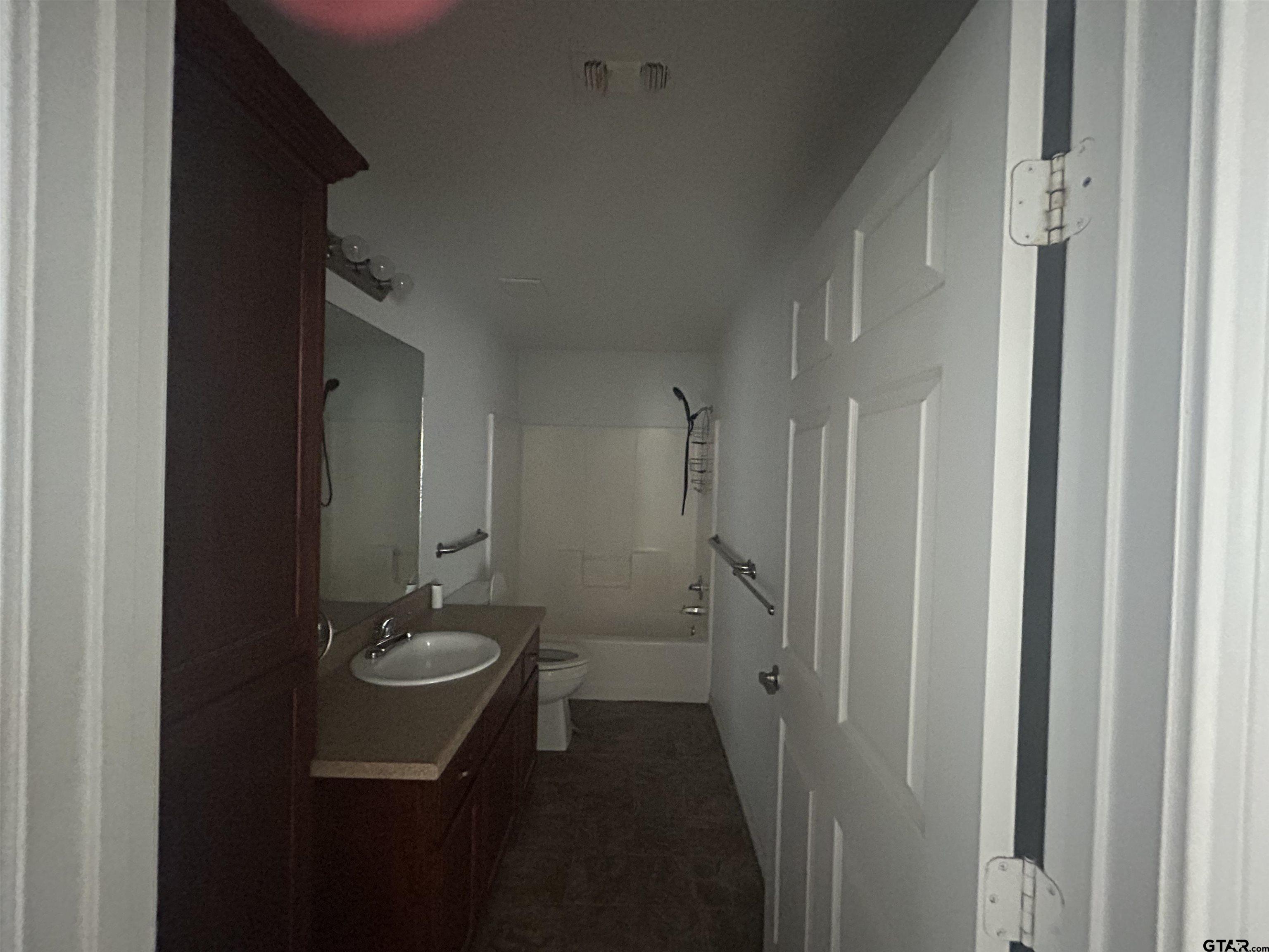 803 Sims Avenue Jacksonville, TX 75766 - Photo 11 of 18 a bathroom with a sink and mirror