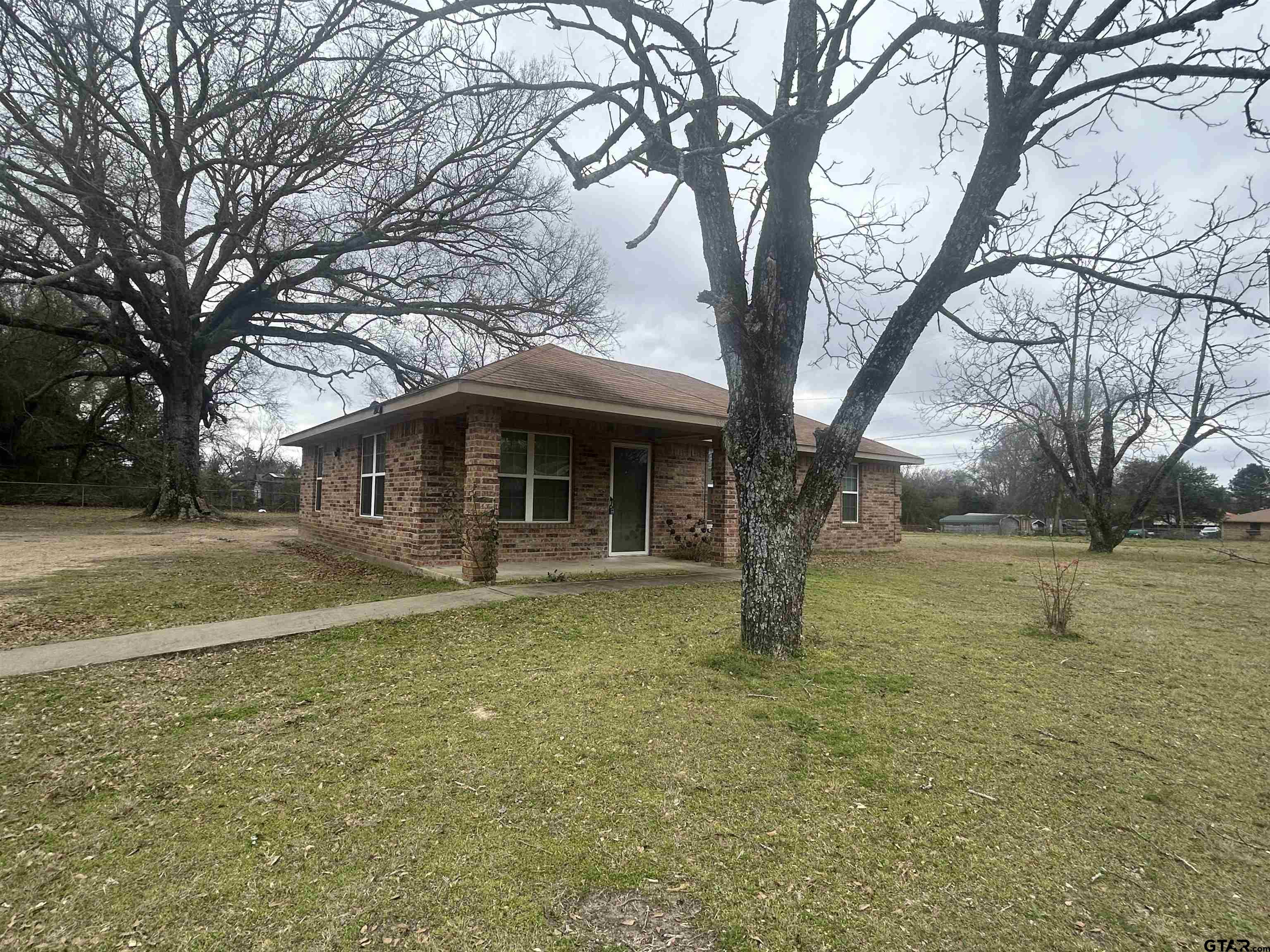 803 Sims Avenue Jacksonville, TX 75766 - Photo 17 of 18 a front view of a house with yard and tree