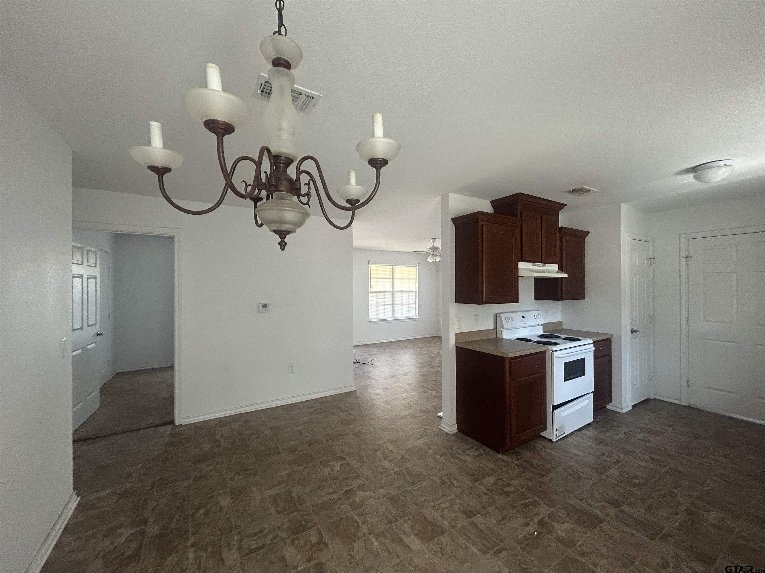 803 Sims Avenue Jacksonville, TX 75766 - Photo 6 of 18 a view of a kitchen with a sink and stove top oven