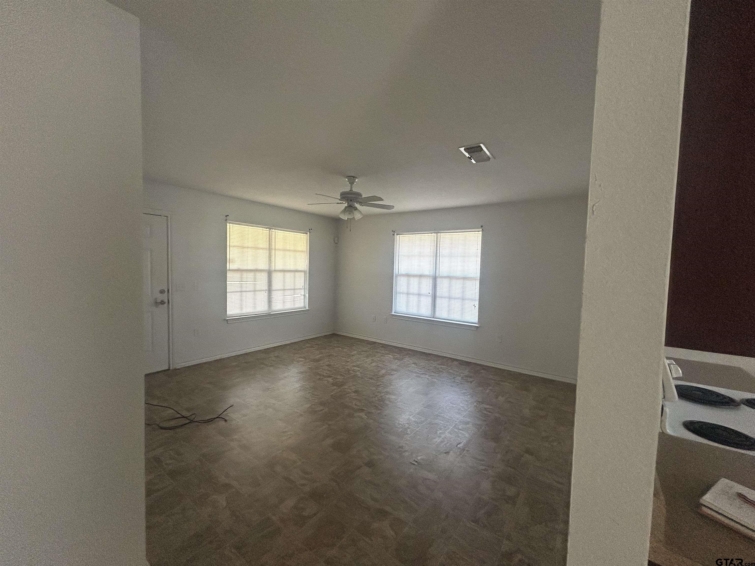 803 Sims Avenue Jacksonville, TX 75766 - Photo 9 of 18 an empty room with windows