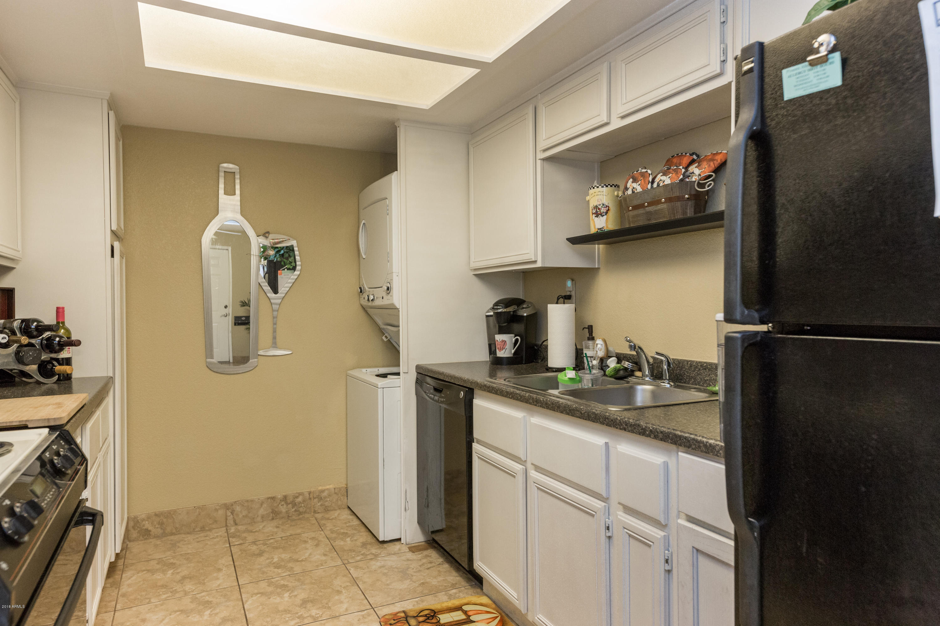 3825 East Camelback Road, Unit 249 Phoenix, AZ 85018 - Photo 12 of 30 a kitchen with a sink and refrigerator