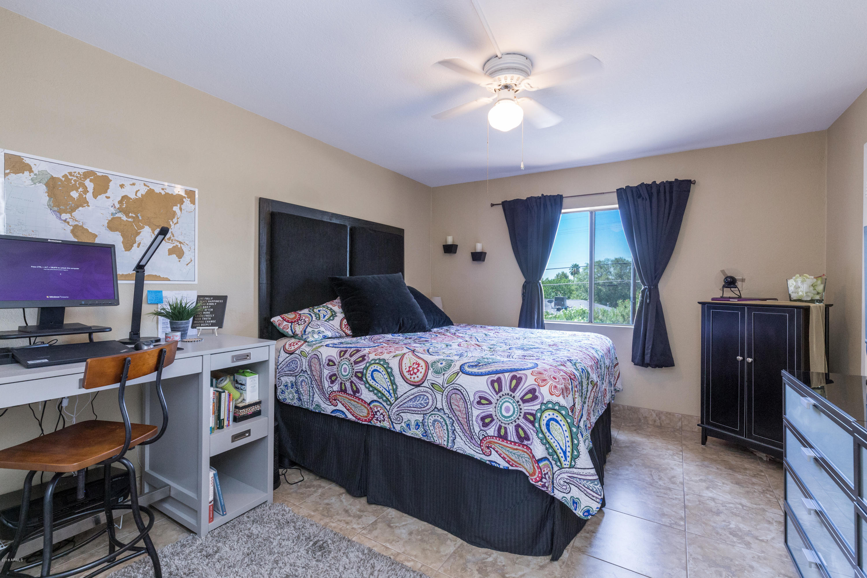 3825 East Camelback Road, Unit 249 Phoenix, AZ 85018 - Photo 14 of 30 a bedroom with a bed and a chandelier