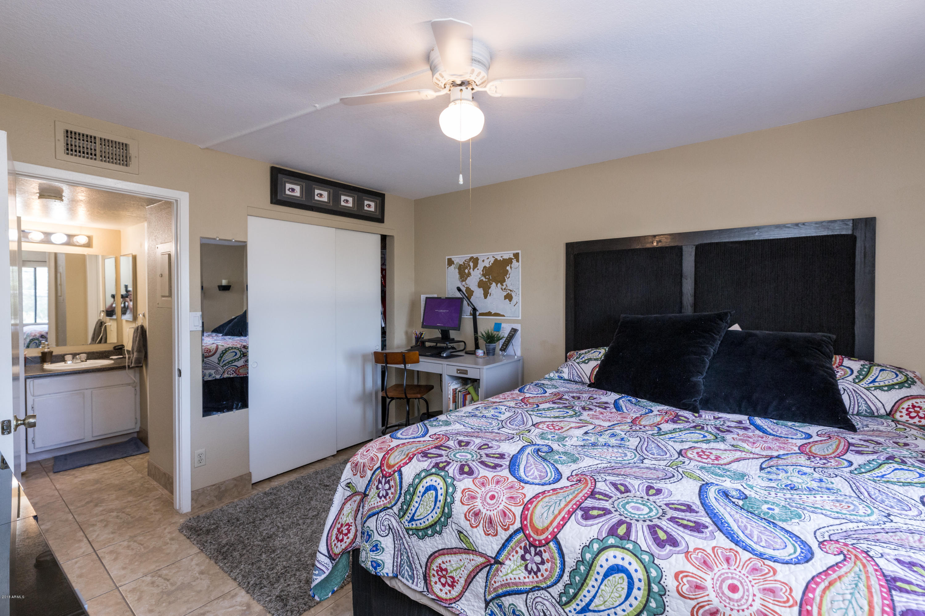 3825 East Camelback Road, Unit 249 Phoenix, AZ 85018 - Photo 15 of 30 a bedroom with a bed and a large mirror on dresser