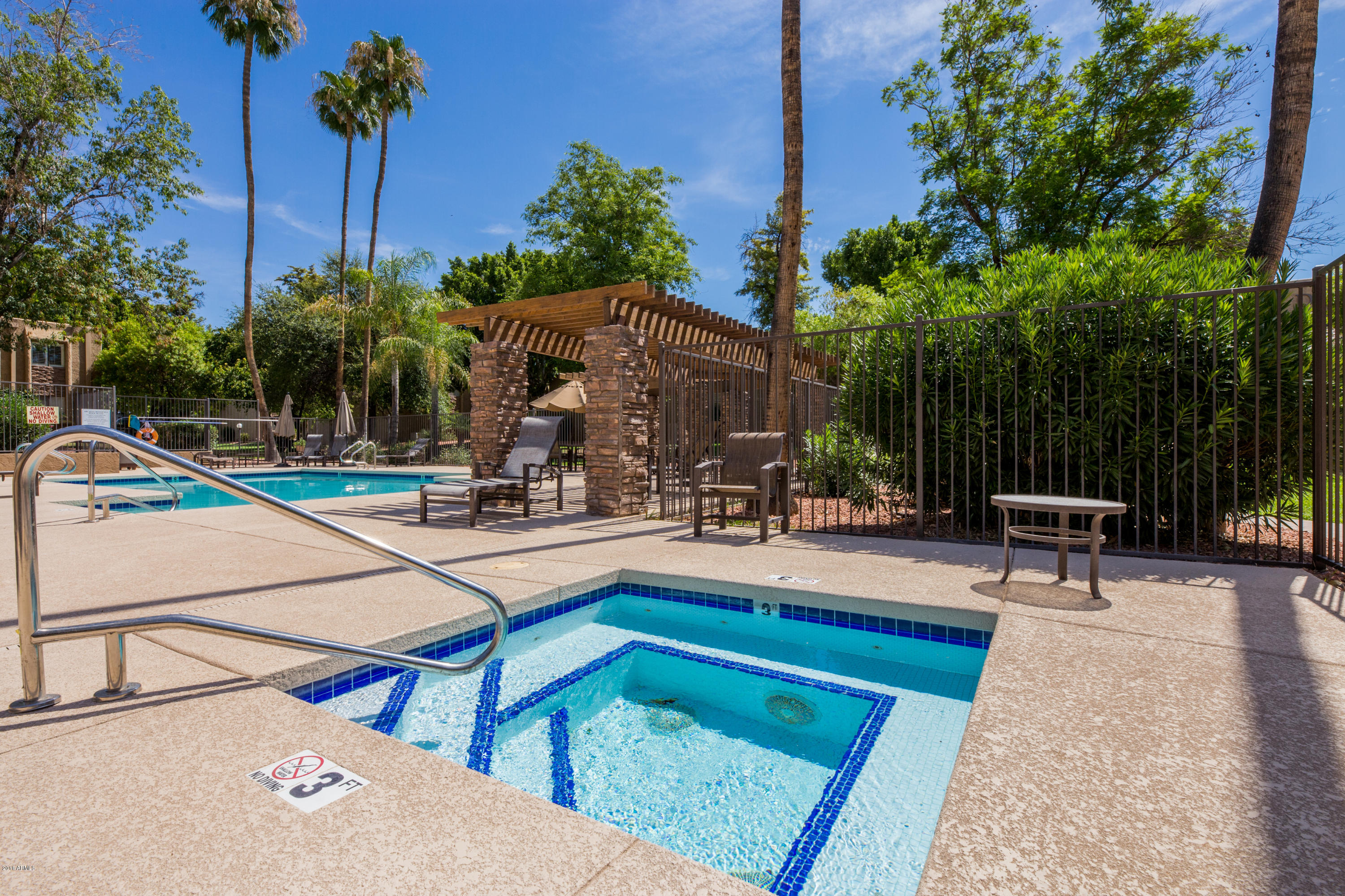 3825 East Camelback Road, Unit 249 Phoenix, AZ 85018 - Photo 21 of 30 a view of a patio with a table and chairs