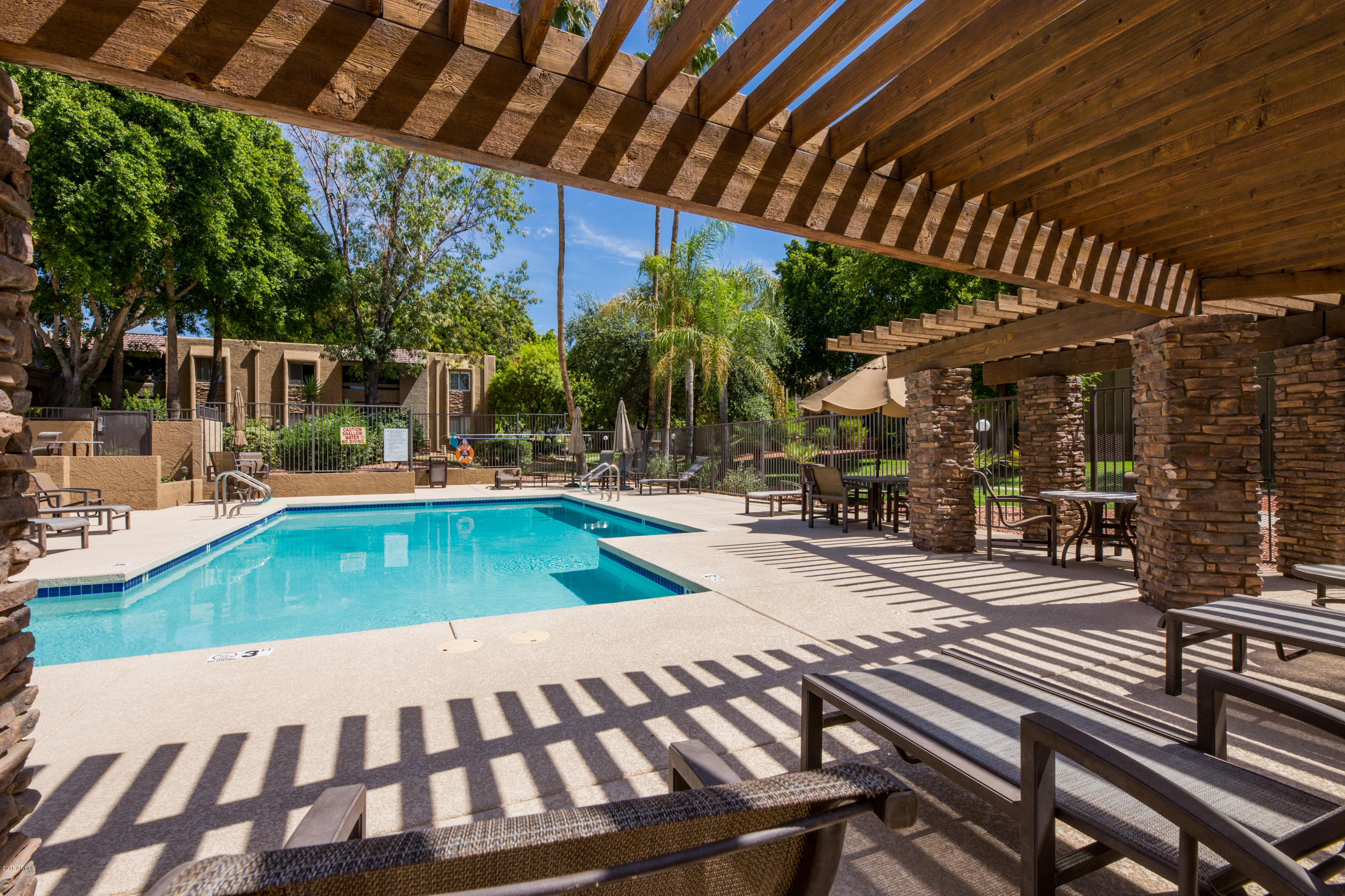 3825 East Camelback Road, Unit 249 Phoenix, AZ 85018 - Photo 22 of 30 a view of a swimming pool with a patio