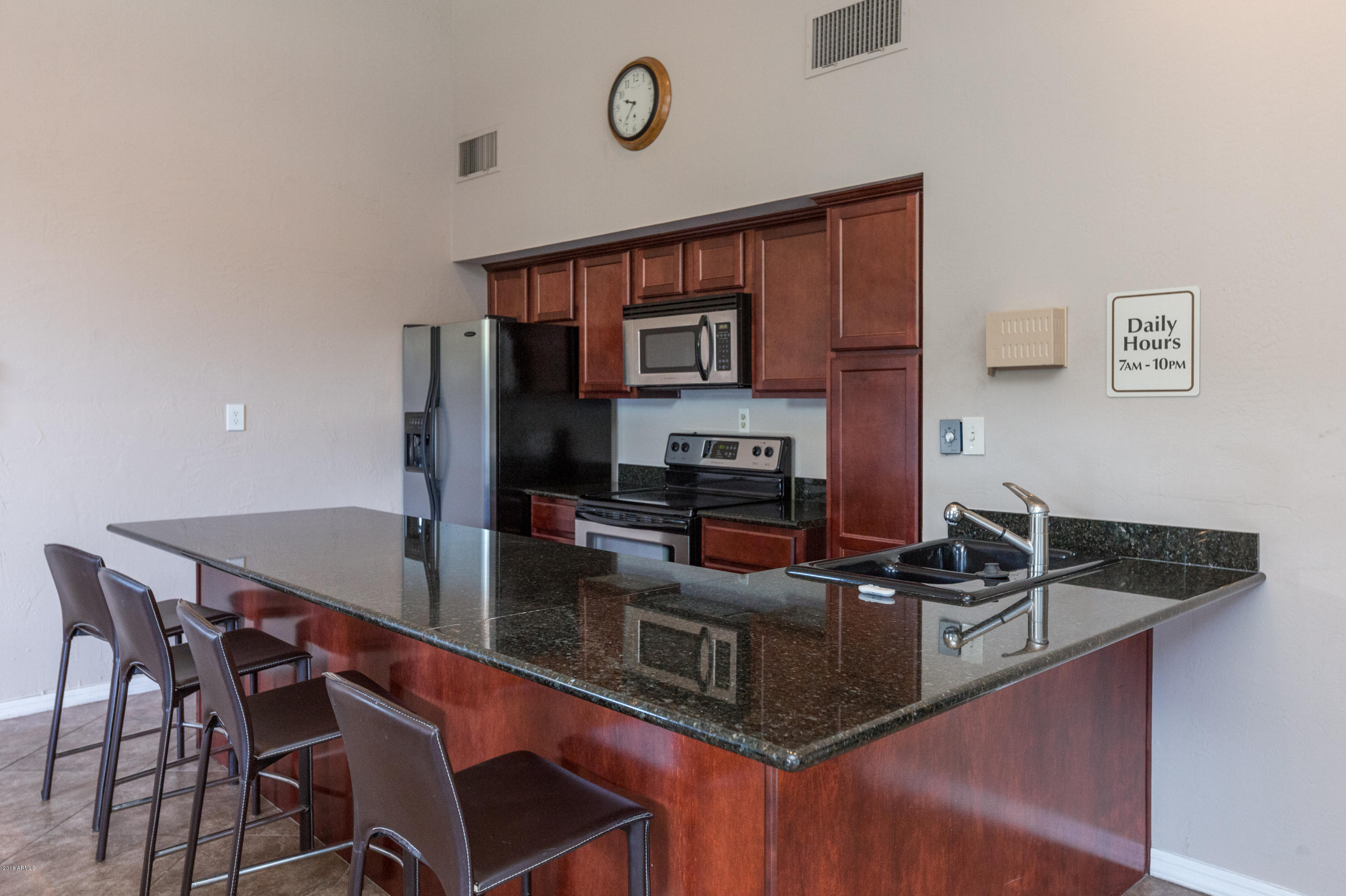 3825 East Camelback Road, Unit 249 Phoenix, AZ 85018 - Photo 24 of 30 a kitchen with stainless steel appliances granite countertop a sink a stove and refrigerator