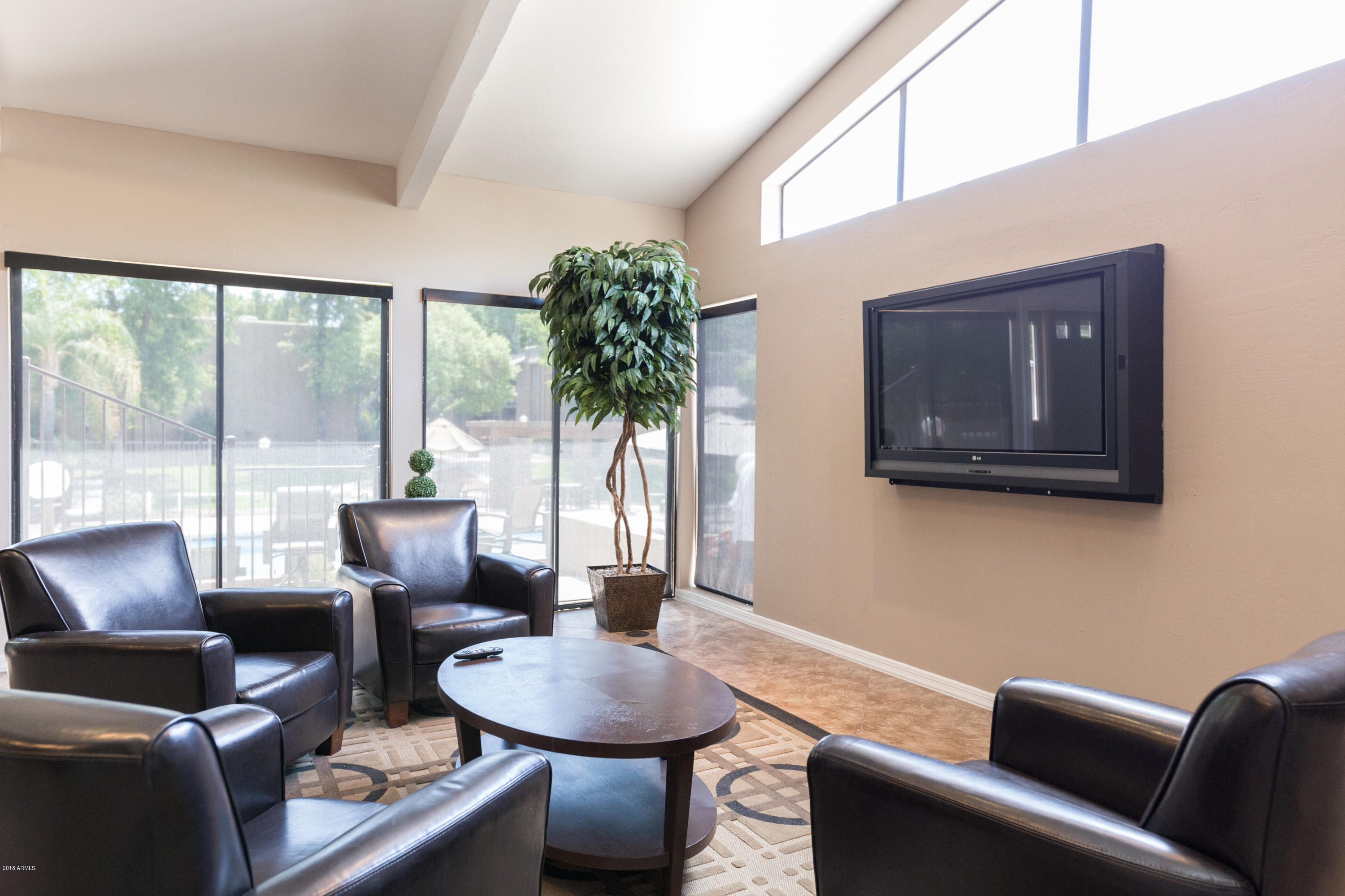 3825 East Camelback Road, Unit 249 Phoenix, AZ 85018 - Photo 26 of 30 a living room with furniture and a large window