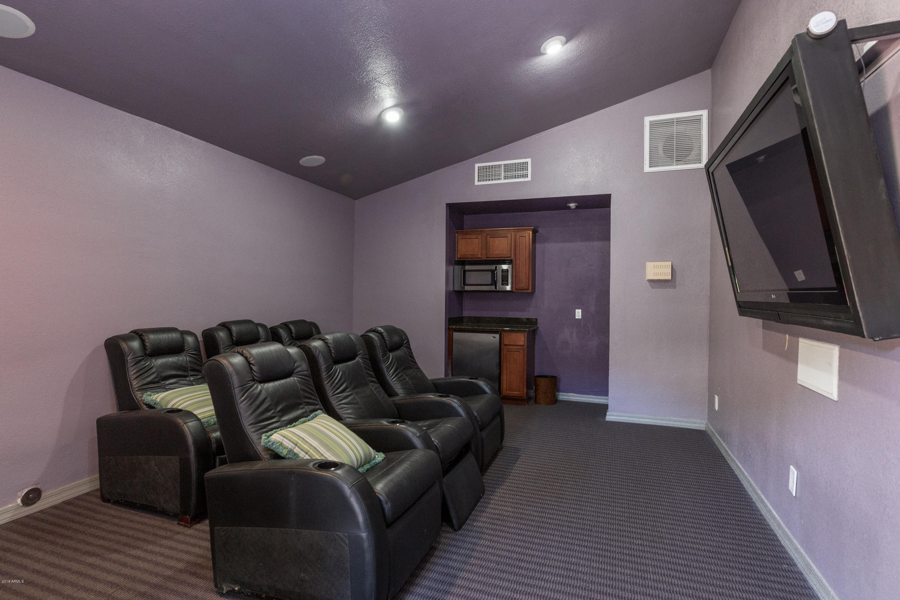 3825 East Camelback Road, Unit 249 Phoenix, AZ 85018 - Photo 28 of 30 a living room with furniture and a flat screen tv