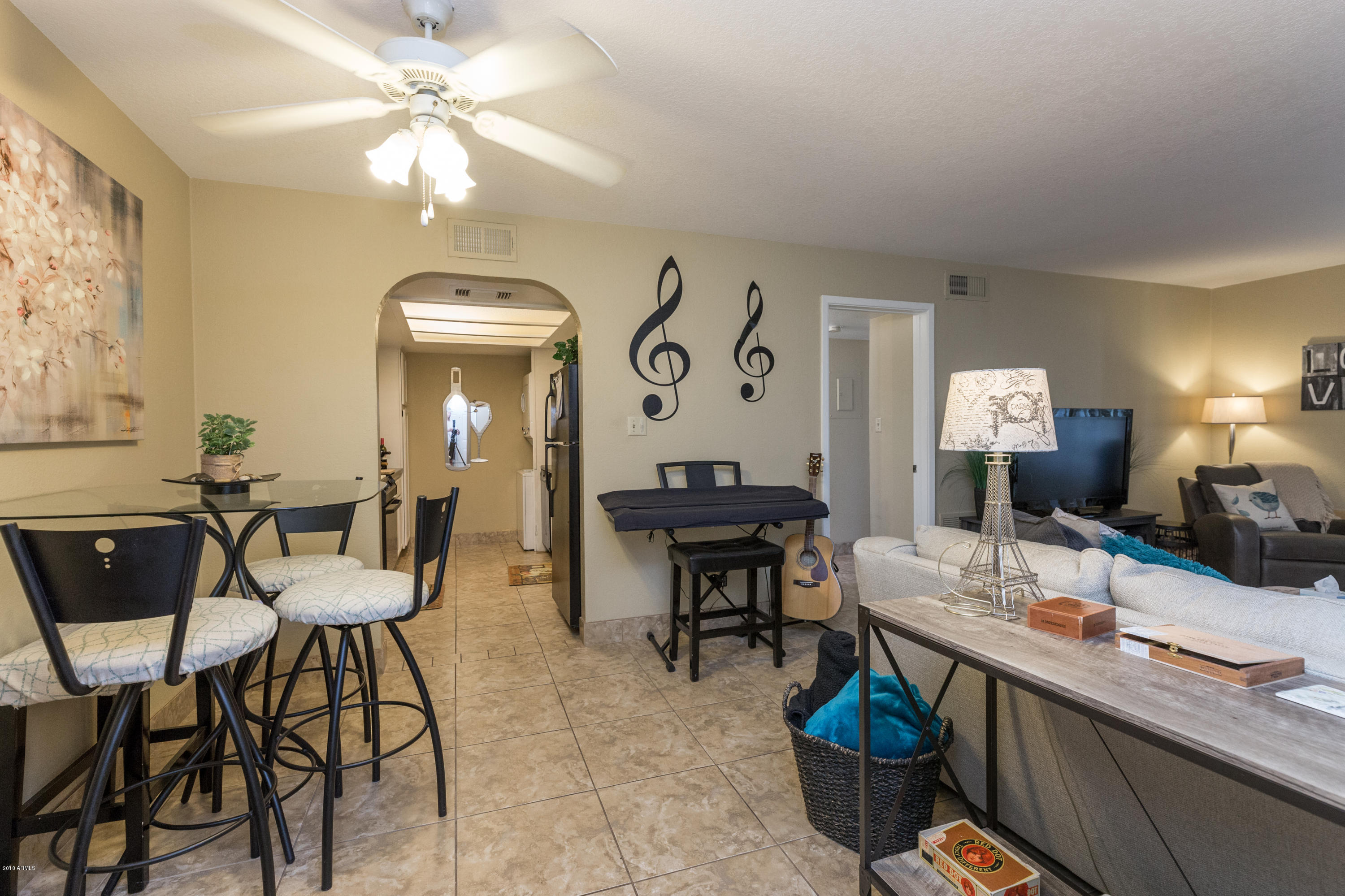 3825 East Camelback Road, Unit 249 Phoenix, AZ 85018 - Photo 7 of 30 a view of a livingroom with furniture and a chandelier