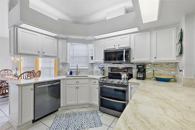 a kitchen with stainless steel appliances a refrigerator and a sink
