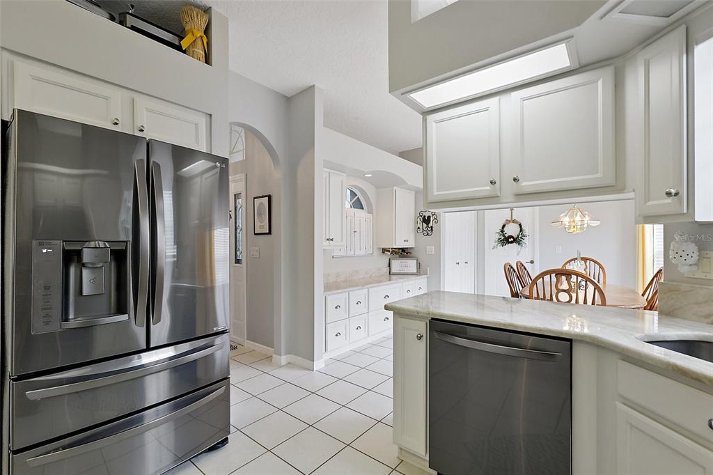 3584 Tropical Seas Loop Tavares, FL 32778 - Photo 16 of 49 a kitchen with stainless steel appliances a refrigerator and a sink