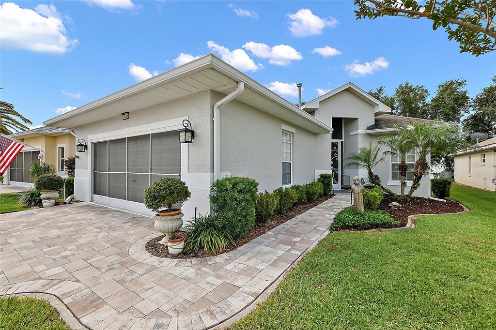 3584 Tropical Seas Loop Tavares, FL 32778 - Photo 2 of 49 a front view of a house with garden