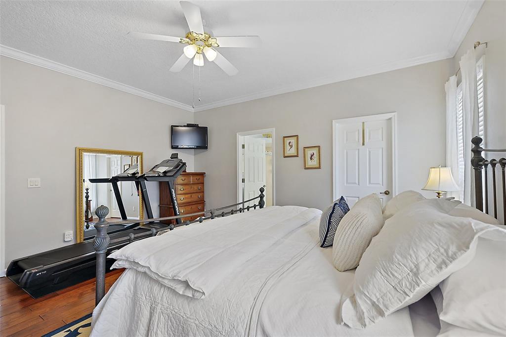 3584 Tropical Seas Loop Tavares, FL 32778 - Photo 22 of 49 a bedroom with a bed and a chandelier