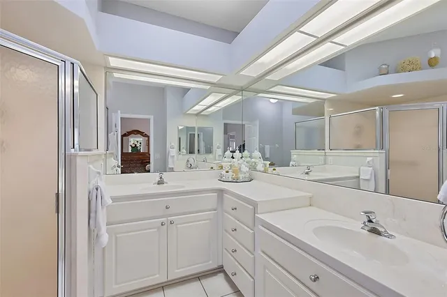 a room with chandelier fan and wooden floor