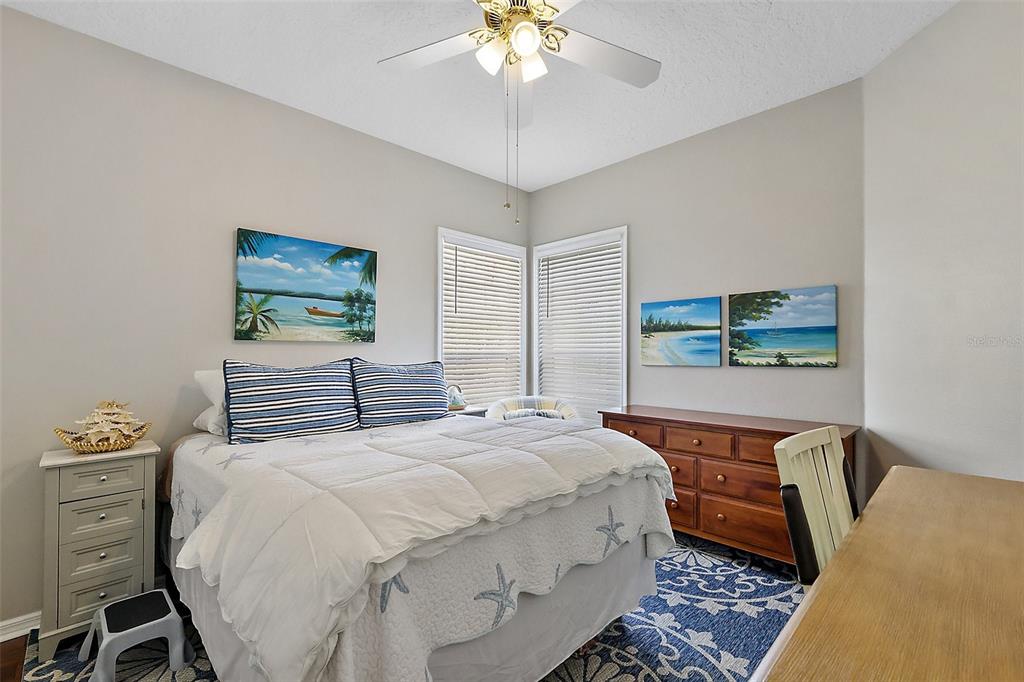 3584 Tropical Seas Loop Tavares, FL 32778 - Photo 28 of 49 a bedroom with a bed and a chandelier