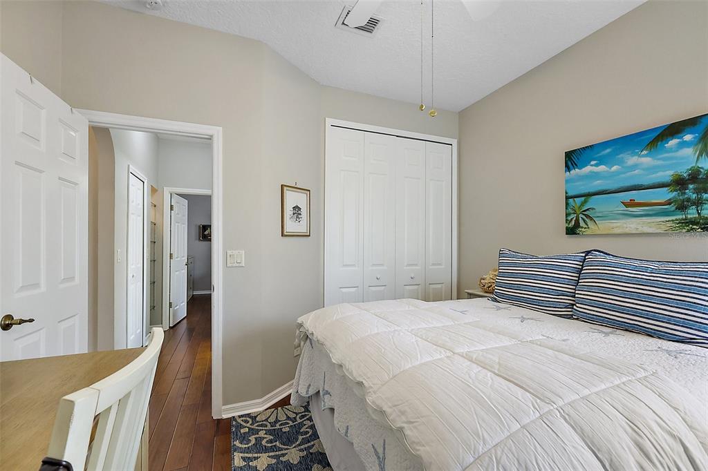 3584 Tropical Seas Loop Tavares, FL 32778 - Photo 29 of 49 a bedroom with a bed and a chandelier