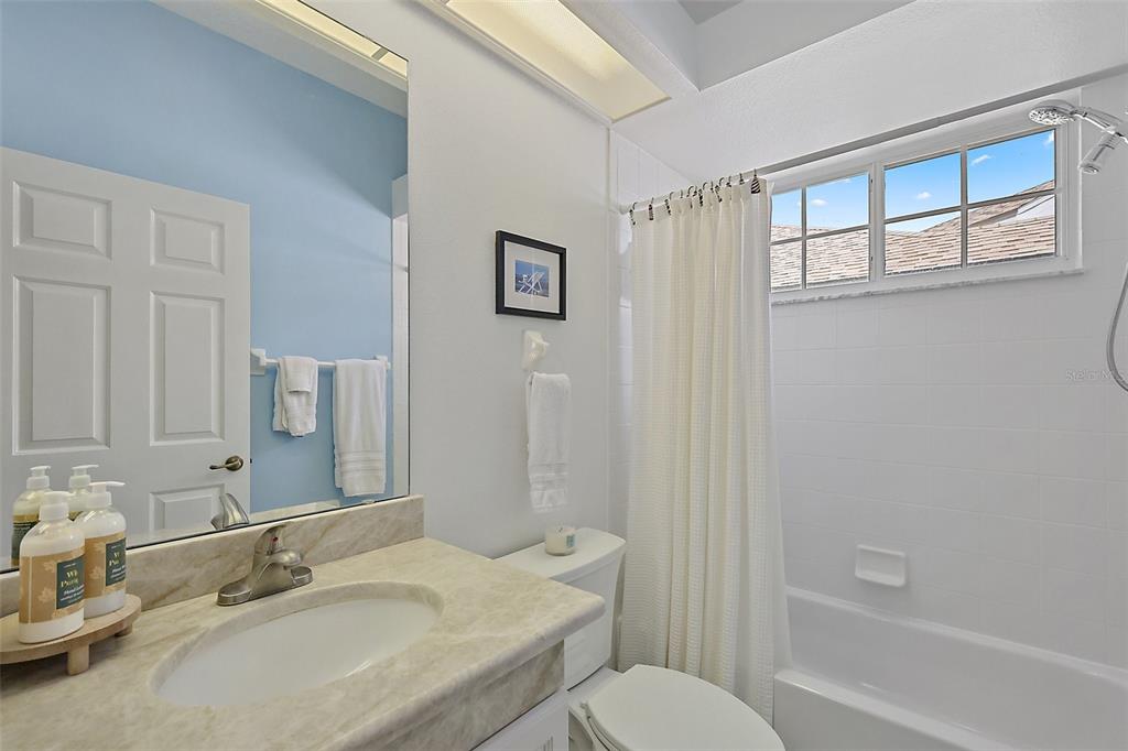 3584 Tropical Seas Loop Tavares, FL 32778 - Photo 30 of 49 a bathroom with a granite countertop sink toilet and shower