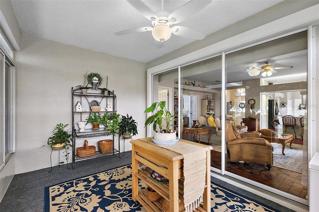 3584 Tropical Seas Loop Tavares, FL 32778 - Photo 32 of 49 a room with chandelier fan and wooden floor