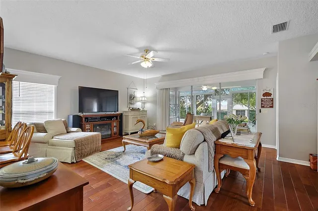a living room with fireplace furniture and a flat screen tv