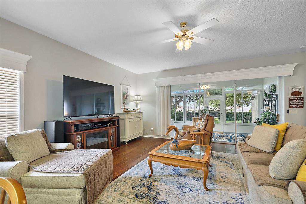 3584 Tropical Seas Loop Tavares, FL 32778 - Photo 10 of 49 a living room with furniture a ceiling fan and a flat screen tv