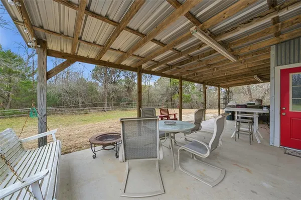 a view of a swimming pool with chairs in patio