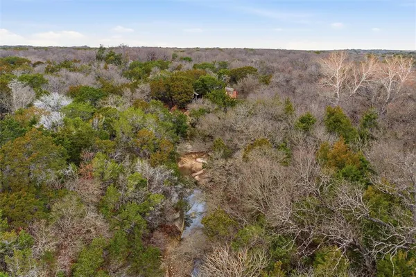 a view of a dry yard with mountains