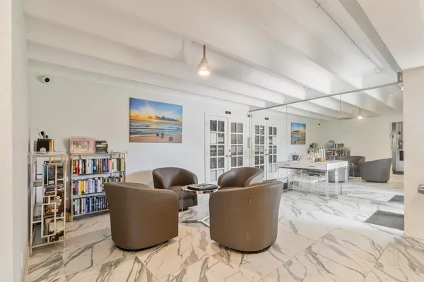 a living room with furniture and a book shelf