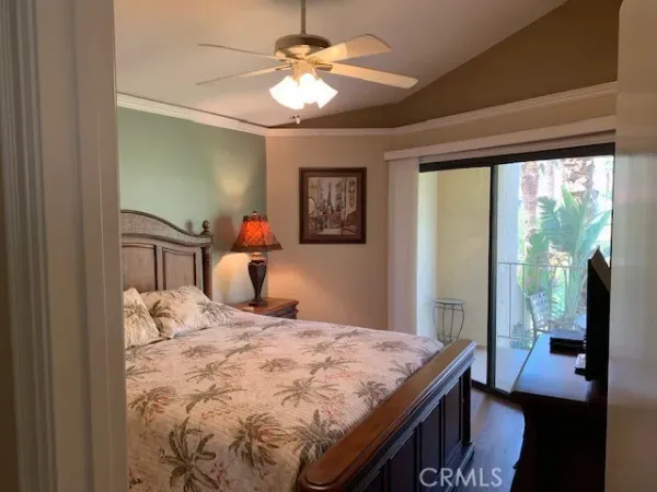 a bedroom with a bed and a television