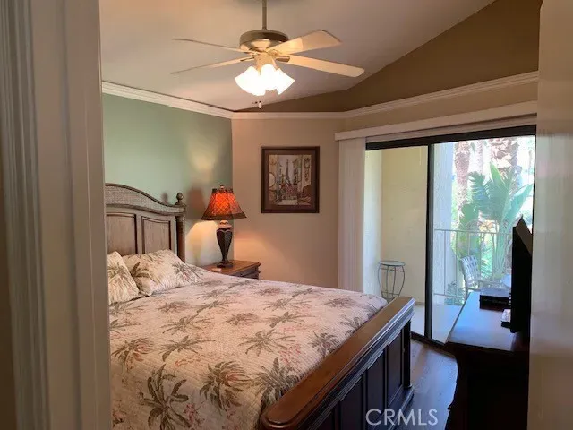 a bedroom with a bed and a television