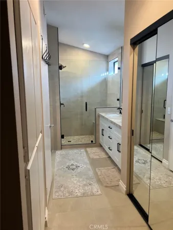 a bathroom with a sink mirror and toilet