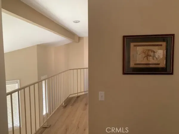 a large bed sitting in a bedroom next to a window