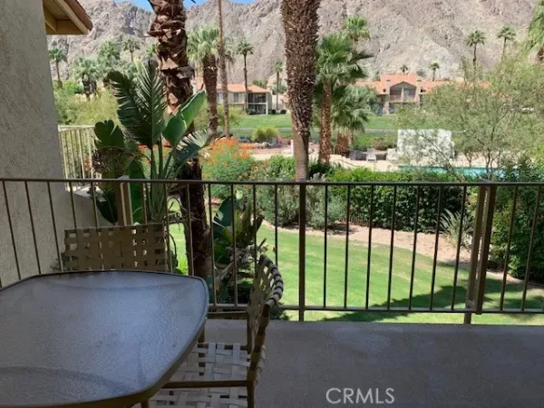 a front view of a house with a garden and yard