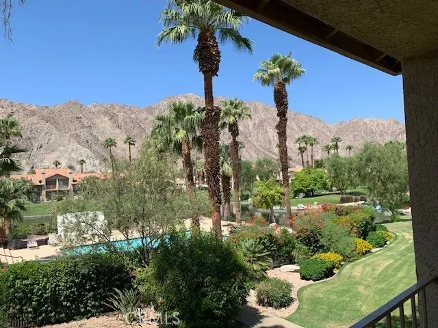 a view of a garden with a building in the background