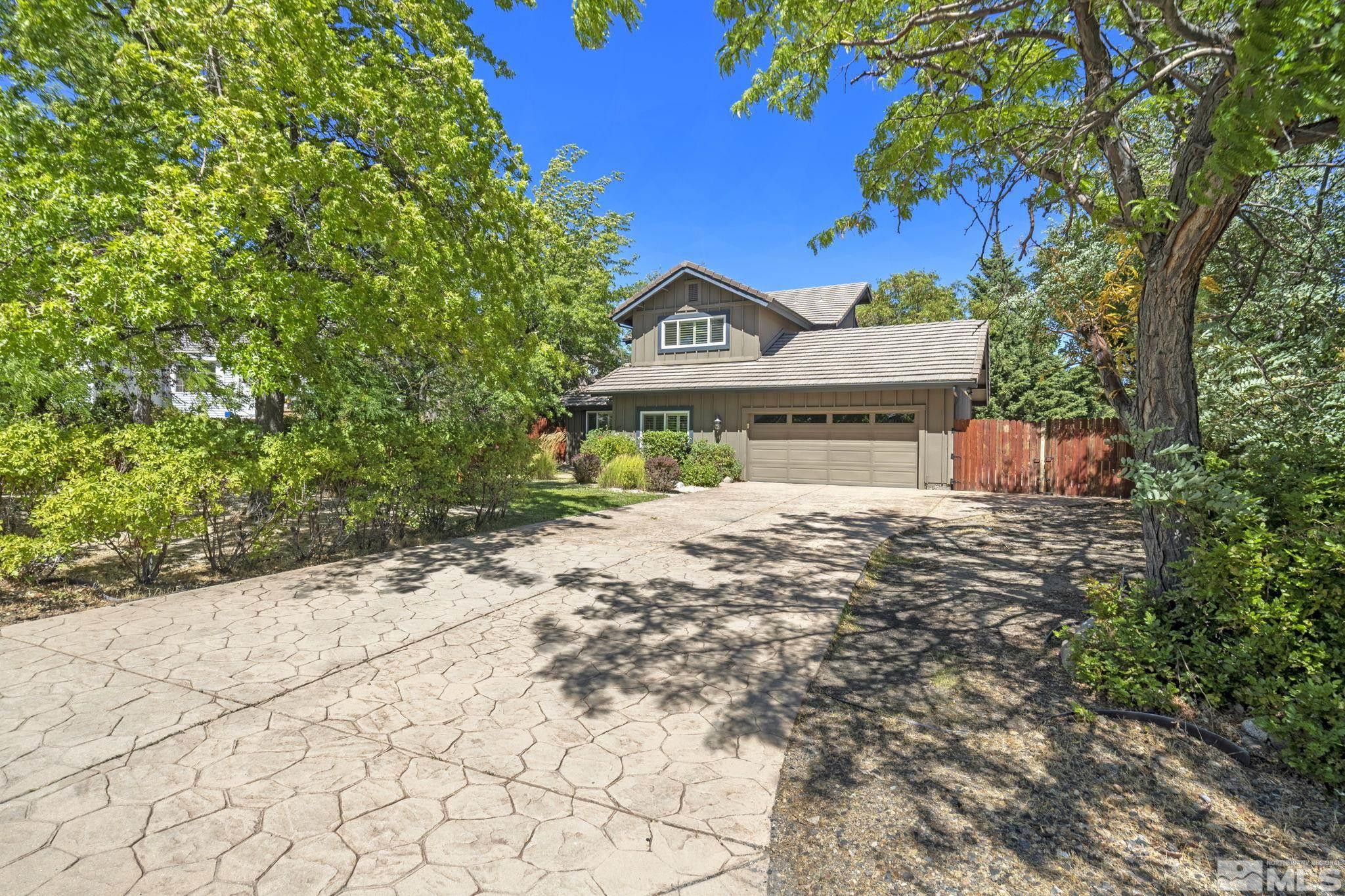 a view of a house with a yard and garage