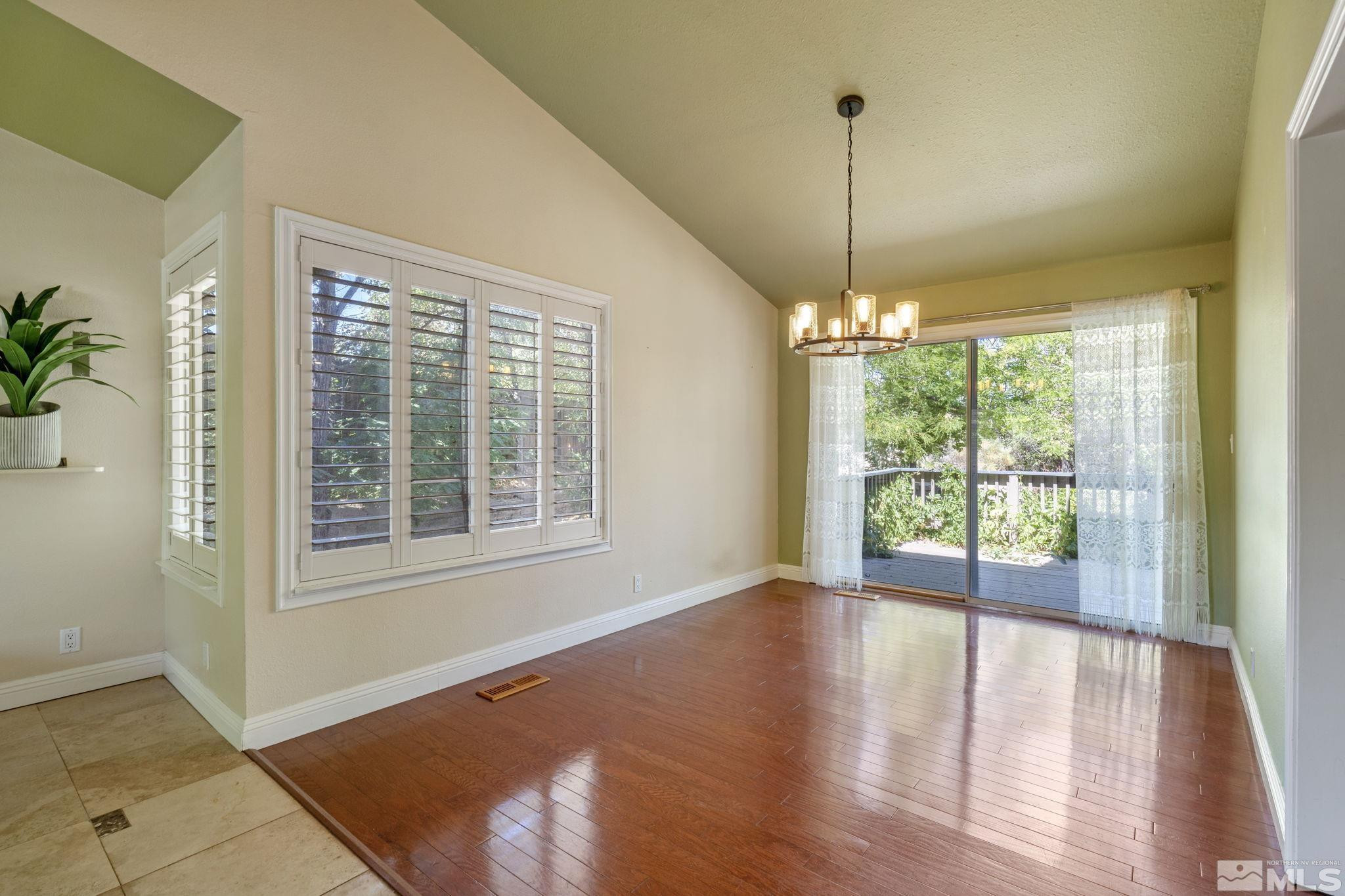 2197 Solitude Drive Reno, NV 89511 - Photo 12 of 40 a view of empty room with wooden floor and fan
