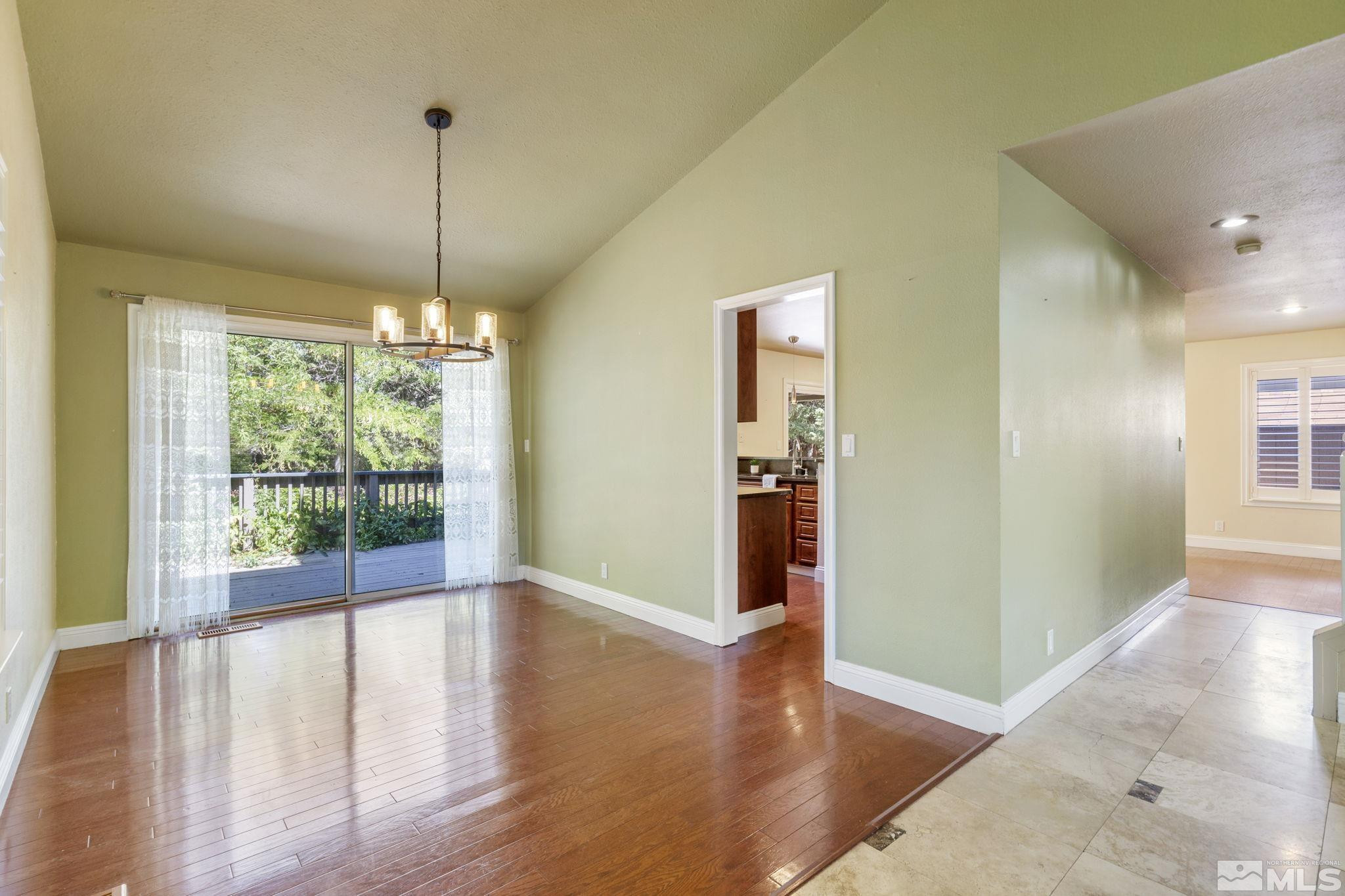 2197 Solitude Drive Reno, NV 89511 - Photo 13 of 40 a view of empty room with wooden floor and fan