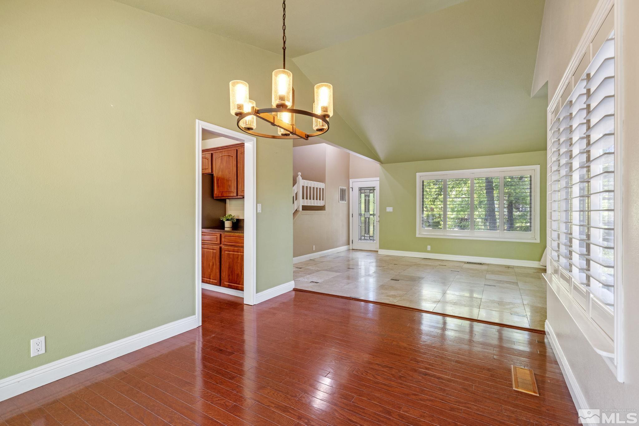 2197 Solitude Drive Reno, NV 89511 - Photo 14 of 40 a view of a room with wooden floor chandelier and windows